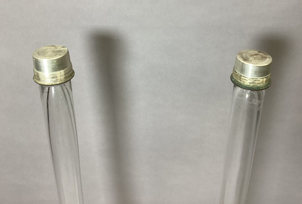 A pair of 40-inch tall 19th-century clear glass trumpet vases with wide flared rims set into painted off-white weighted bases. View XII