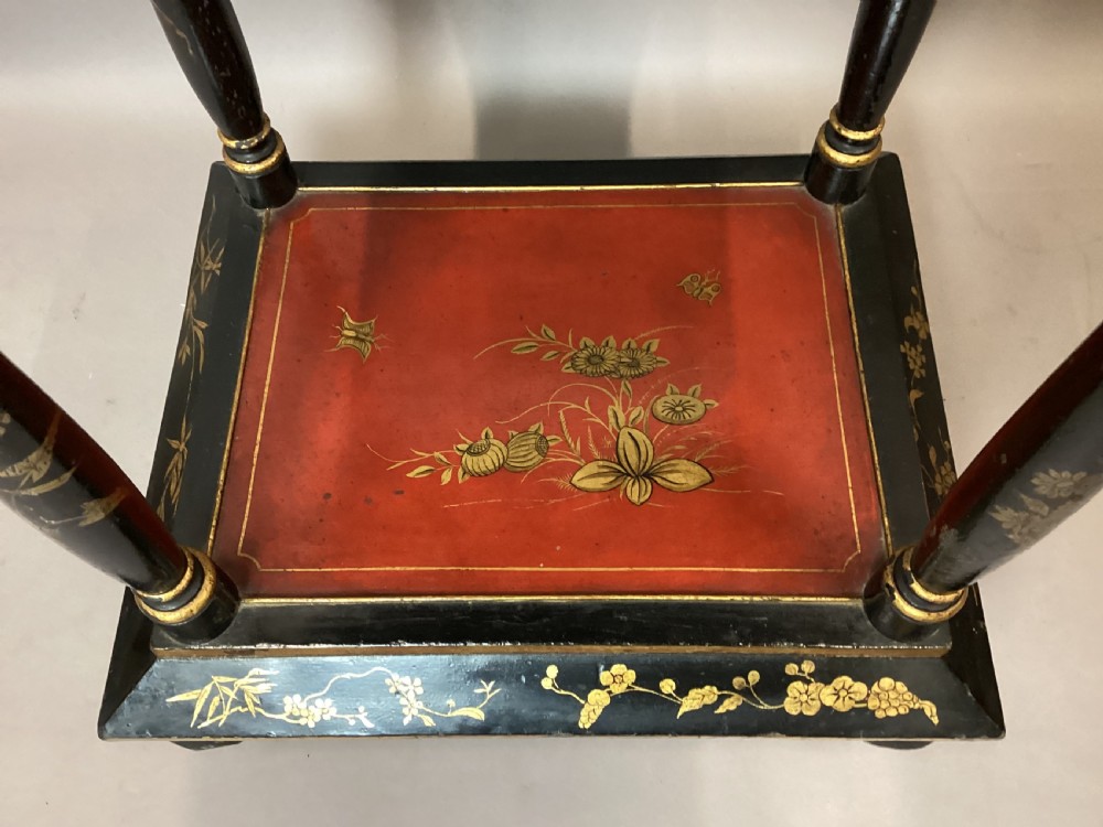 A Regency two-tier occasional table featuring black lacquer with gilt hand-painted Chinoiserie scenes and a red lower shelf. View V