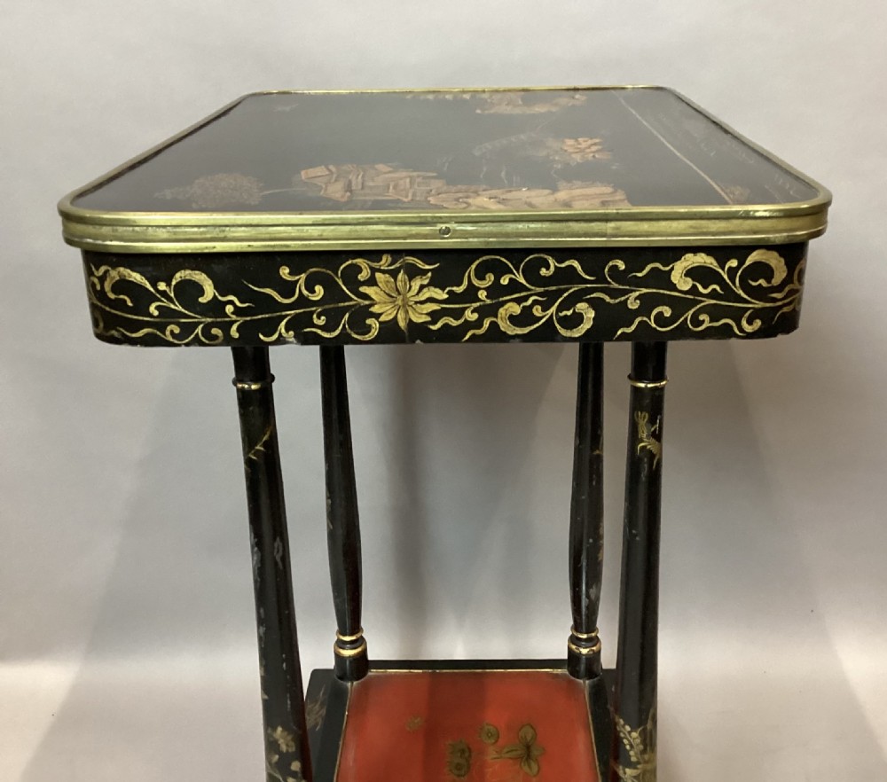 A Regency two-tier occasional table featuring black lacquer with gilt hand-painted Chinoiserie scenes and a red lower shelf. View VII