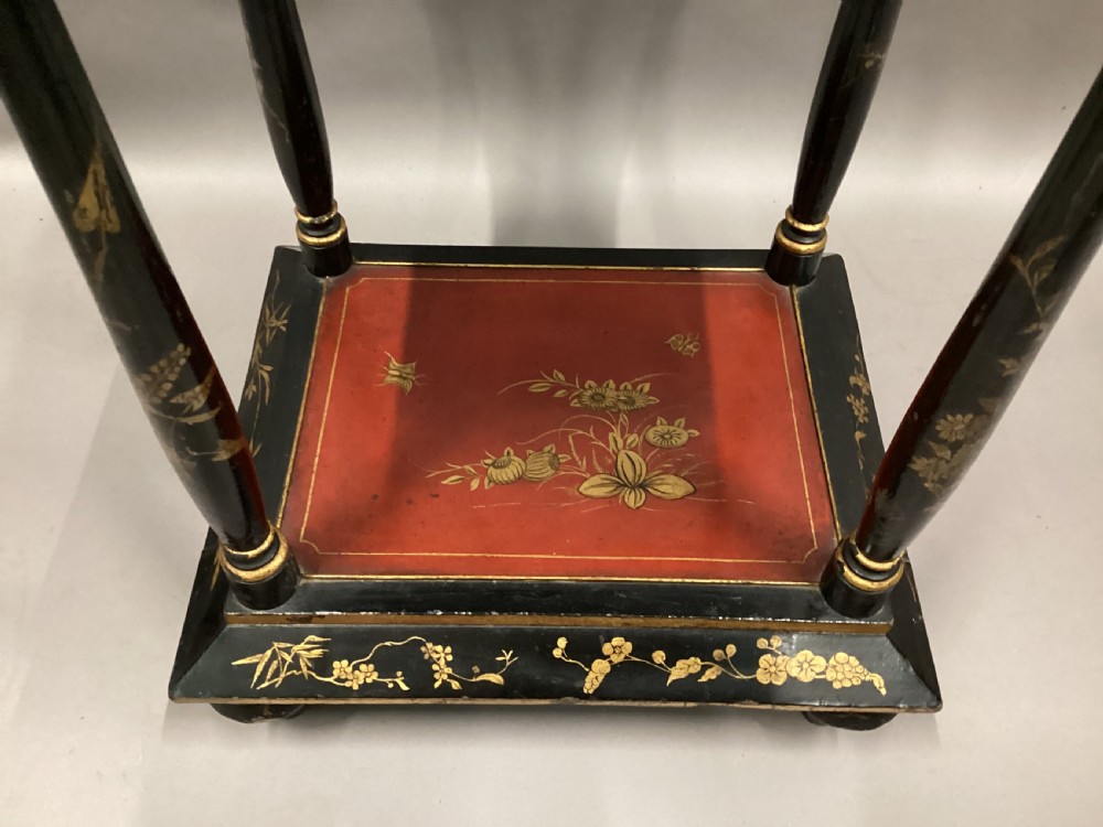 A Regency two-tier occasional table featuring black lacquer with gilt hand-painted Chinoiserie scenes and a red lower shelf. View XIV