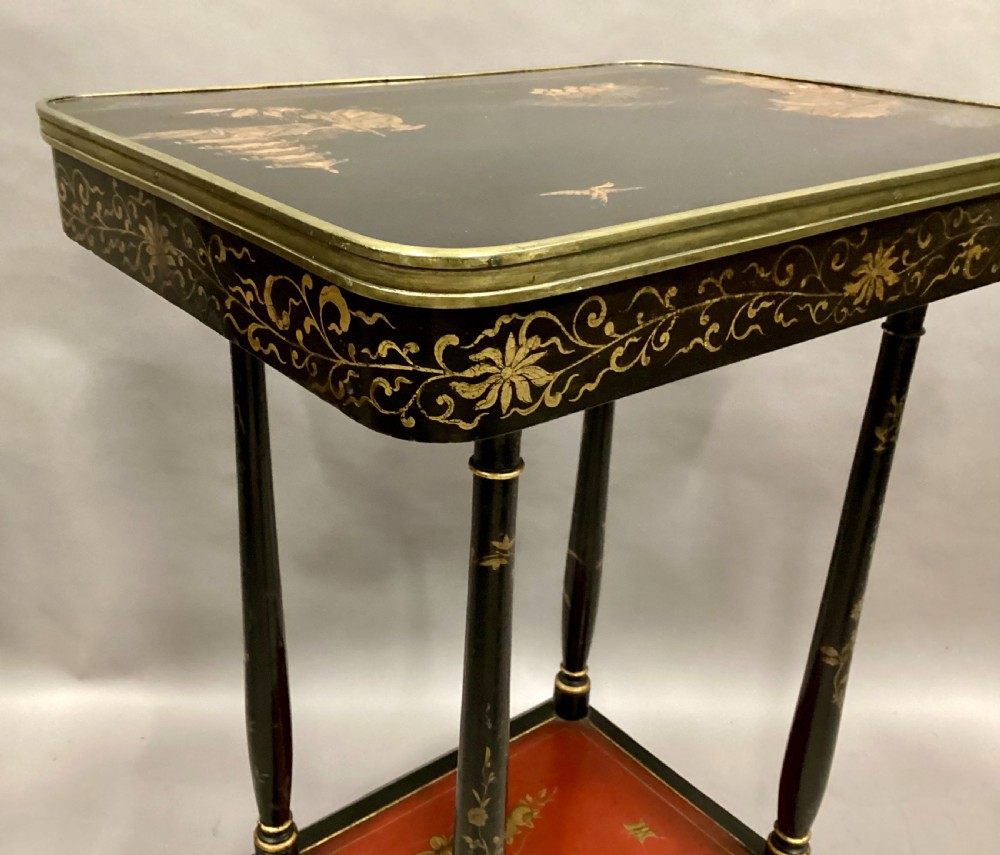 A Regency two-tier occasional table featuring black lacquer with gilt hand-painted Chinoiserie scenes and a red lower shelf. View XVII