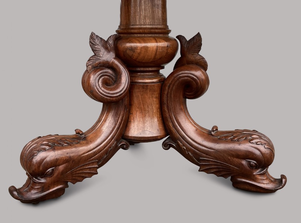 An octagonal 19th-century centre table with a geometric inlaid specimen marble top supported on a carved walnut pedestal base with scroll feet. View II
