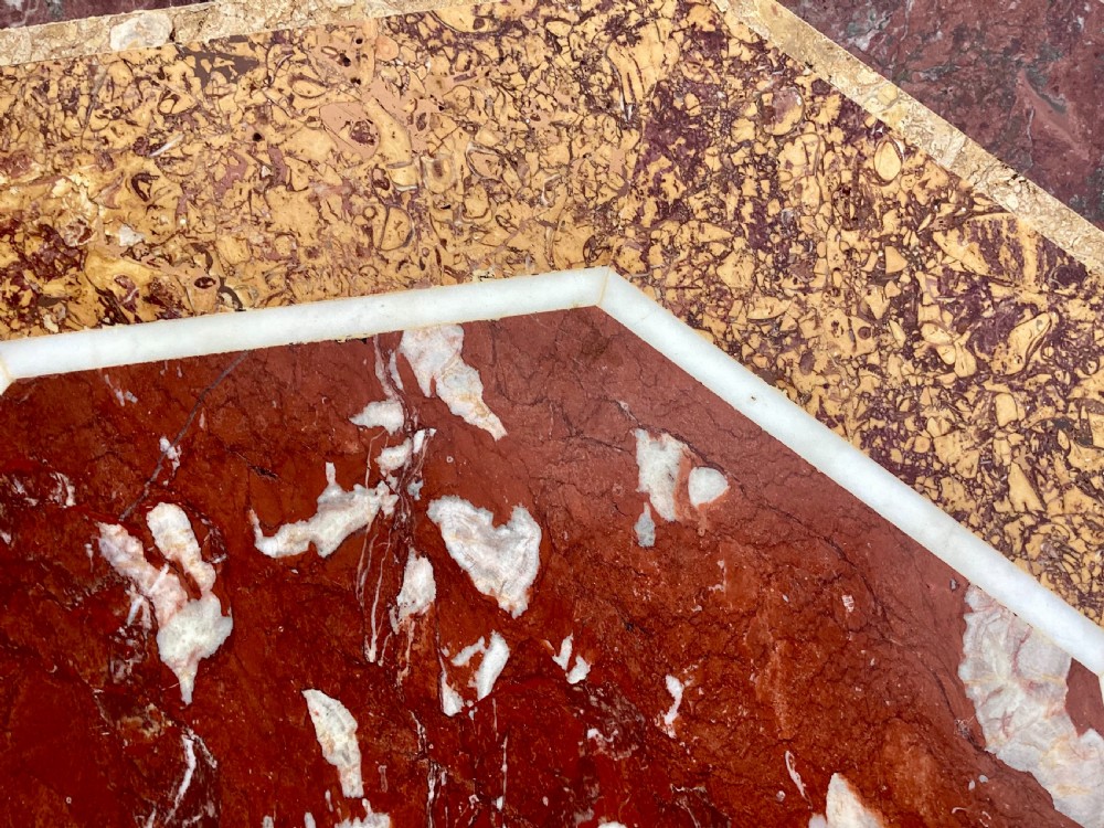 An octagonal 19th-century centre table with a geometric inlaid specimen marble top supported on a carved walnut pedestal base with scroll feet. View XVI