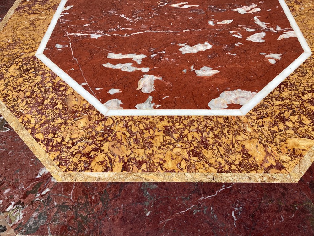 An octagonal 19th-century centre table with a geometric inlaid specimen marble top supported on a carved walnut pedestal base with scroll feet. View XVII