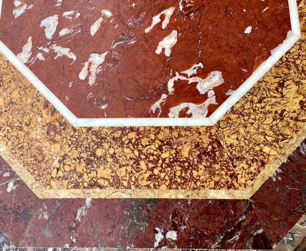 An octagonal 19th-century centre table with a geometric inlaid specimen marble top supported on a carved walnut pedestal base with scroll feet. View XXII