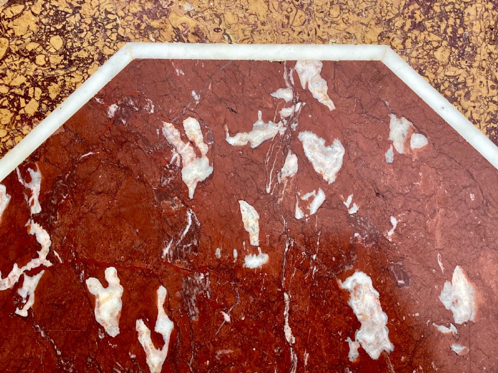 An octagonal 19th-century centre table with a geometric inlaid specimen marble top supported on a carved walnut pedestal base with scroll feet. View XXIV