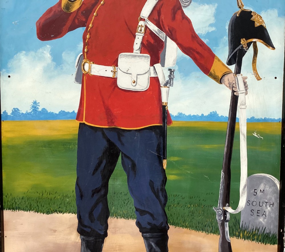A large rectangular hand-painted panel depicting a soldier in a red tunic and blue trousers drinking from a tankard alongside military gear and text reading 5th Hants Volunteer. View VIII