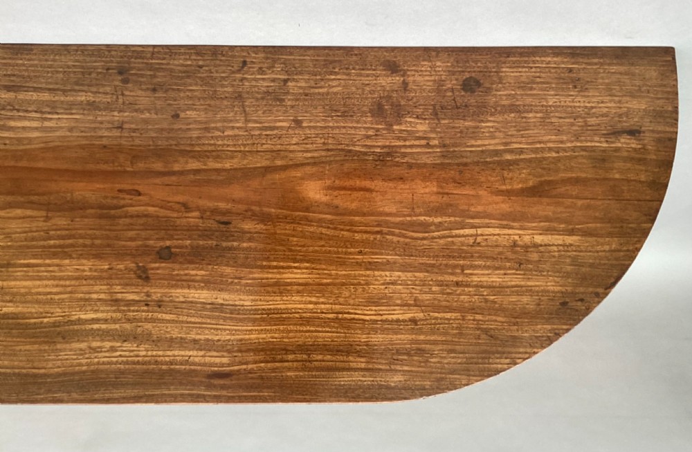 A George III mahogany demilune console table featuring a semi-circular top, plain apron, and four long square tapered legs. View VI