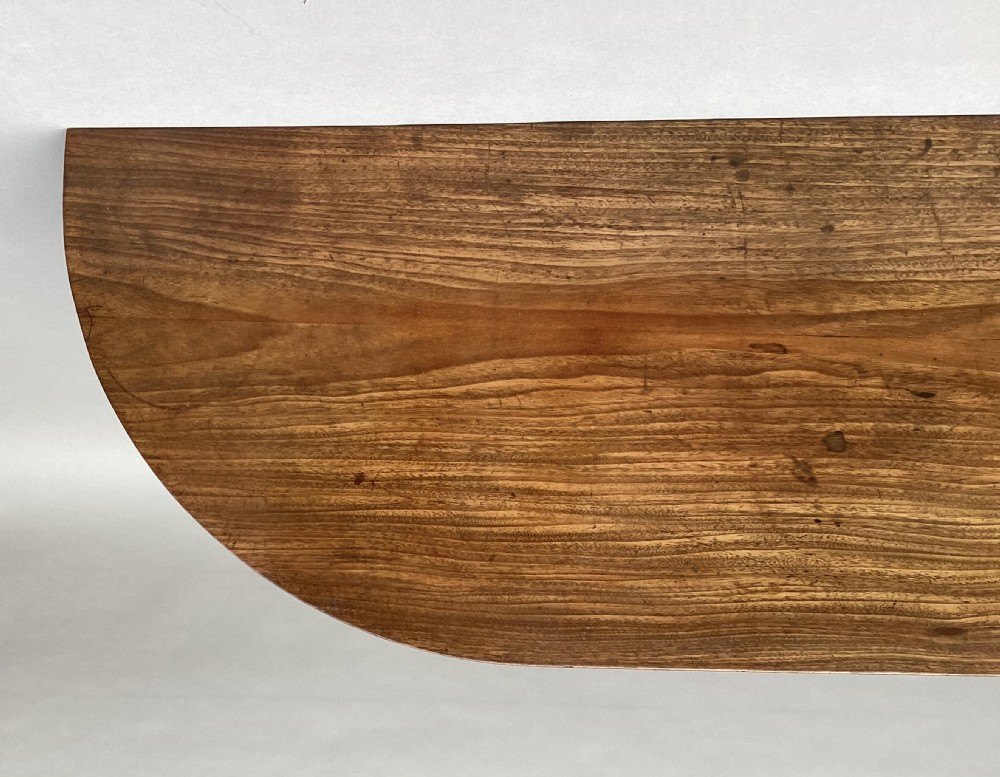 A George III mahogany demilune console table featuring a semi-circular top, plain apron, and four long square tapered legs. View VII