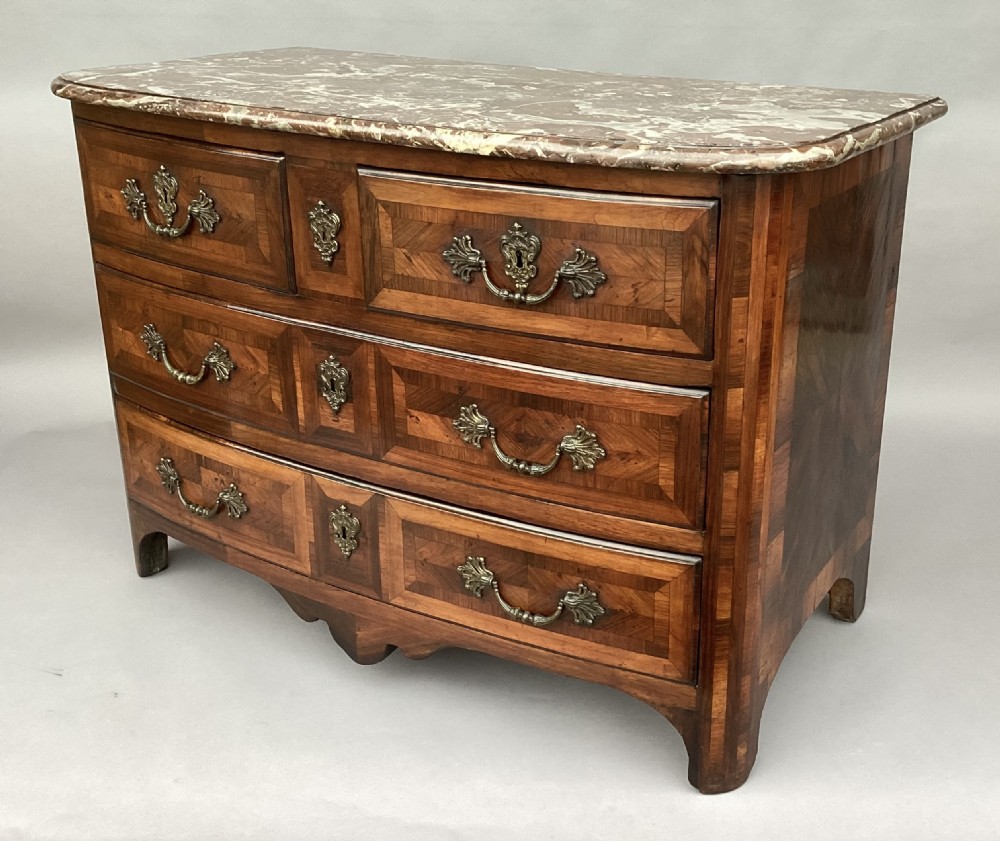 An 18th-century Louis XV bow-fronted kingwood commode featuring geometric parquetry drawers, cast bronze handles, keyhole escutcheons, and a thick marble top. View II