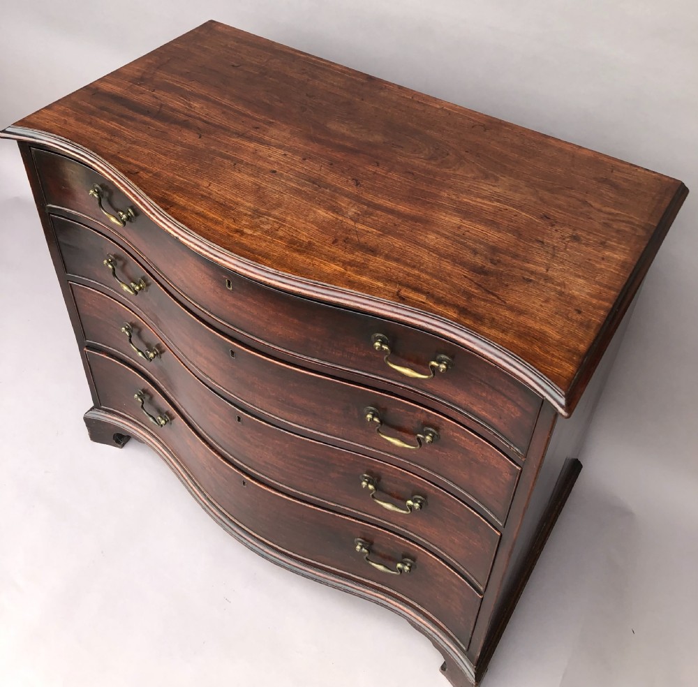George III Chippendale mahogany serpentine chest of drawers; attributed to Thomas Chippendale