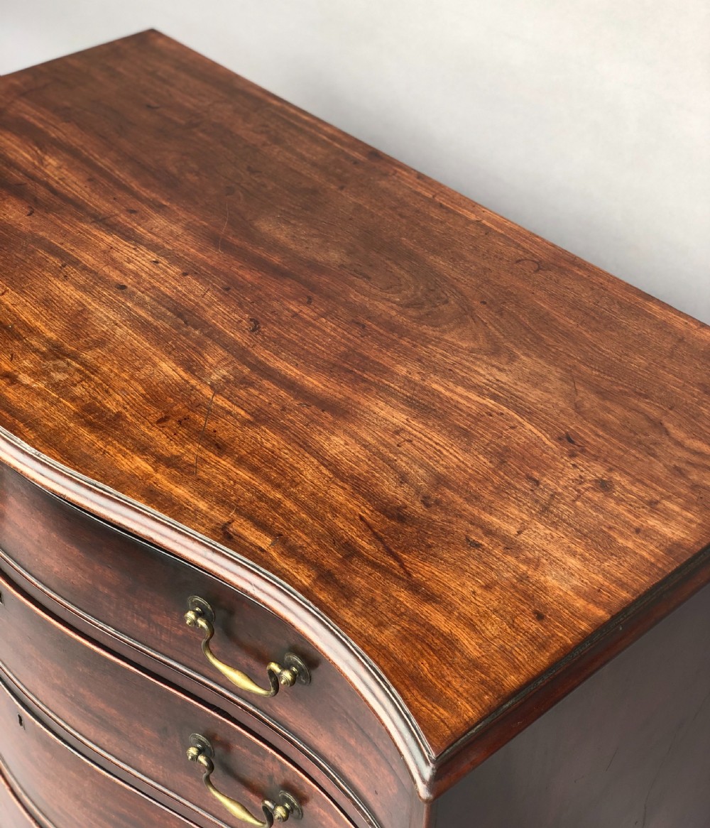 George III Chippendale mahogany serpentine chest of drawers; attributed to Thomas Chippendale View IX