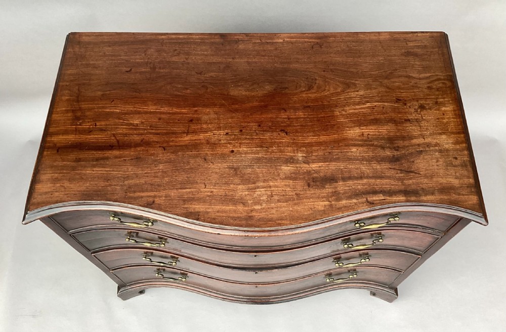 George III Chippendale mahogany serpentine chest of drawers; attributed to Thomas Chippendale View XVII