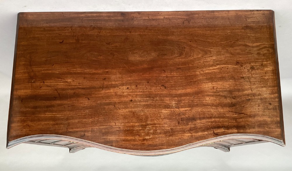 George III Chippendale mahogany serpentine chest of drawers; attributed to Thomas Chippendale View XX