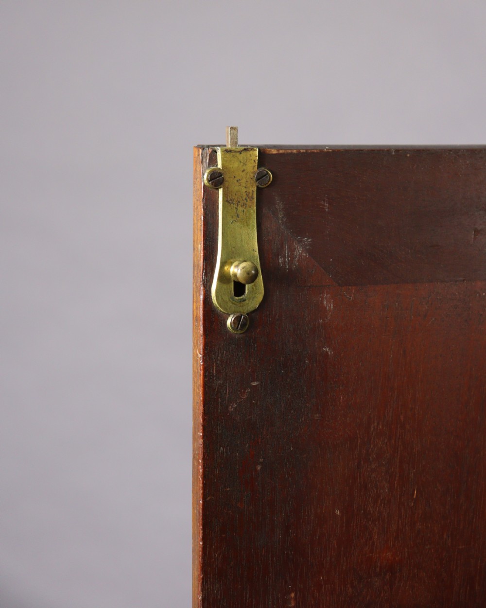 An eighteenth-century George II red walnut cabinet on a kneehole base with open doors revealing fitted internal drawers and pigeonholes above brass-handled drawers. View X
