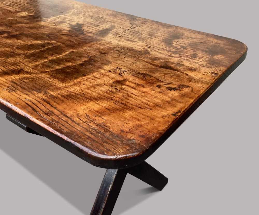 A Georgian elm tavern table featuring a long rectangular polished timber top over a dark X-frame base. View VII