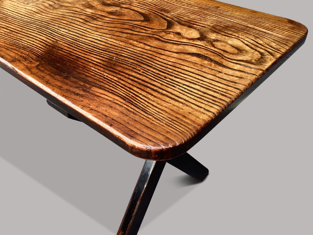 A Georgian elm tavern table featuring a long rectangular polished timber top over a dark X-frame base. View XVIII