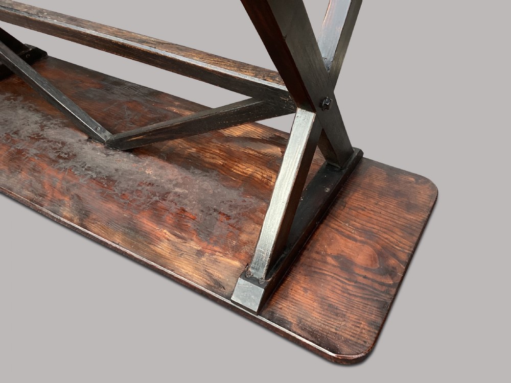 A Georgian elm tavern table featuring a long rectangular polished timber top over a dark X-frame base. View XXI