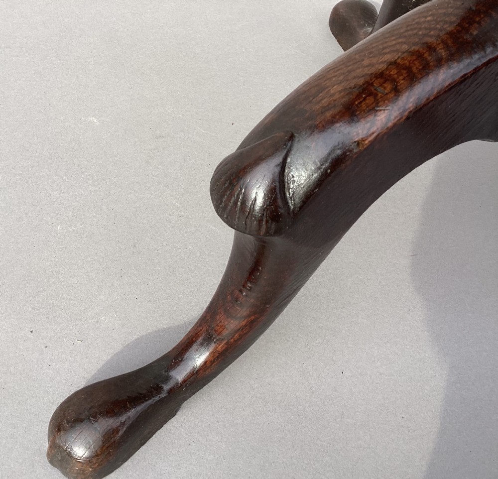 An 18th-century Irish Georgian burr oak tripod wine table featuring a circular top, turned central pedestal, and three cabriole legs terminating in pad feet. View XVI