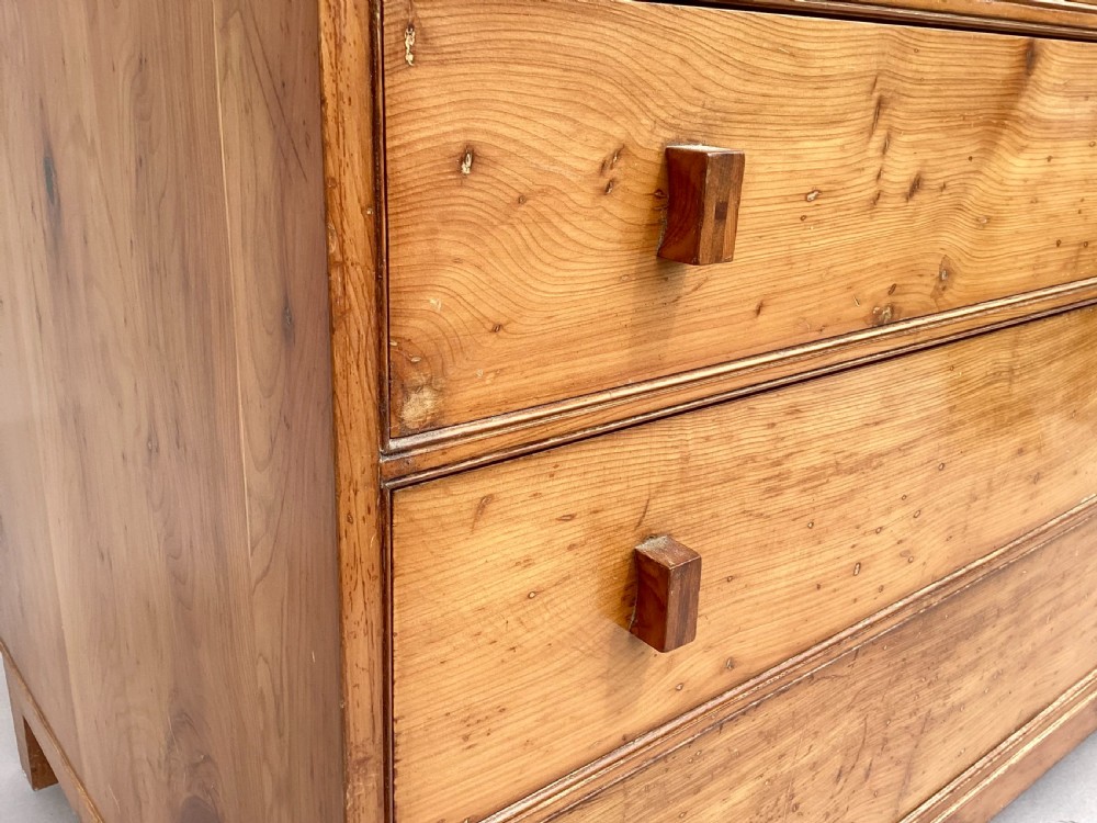 An Arts and Crafts solid yew wood chest featuring six graduated drawers with simple square wooden pulls. View III