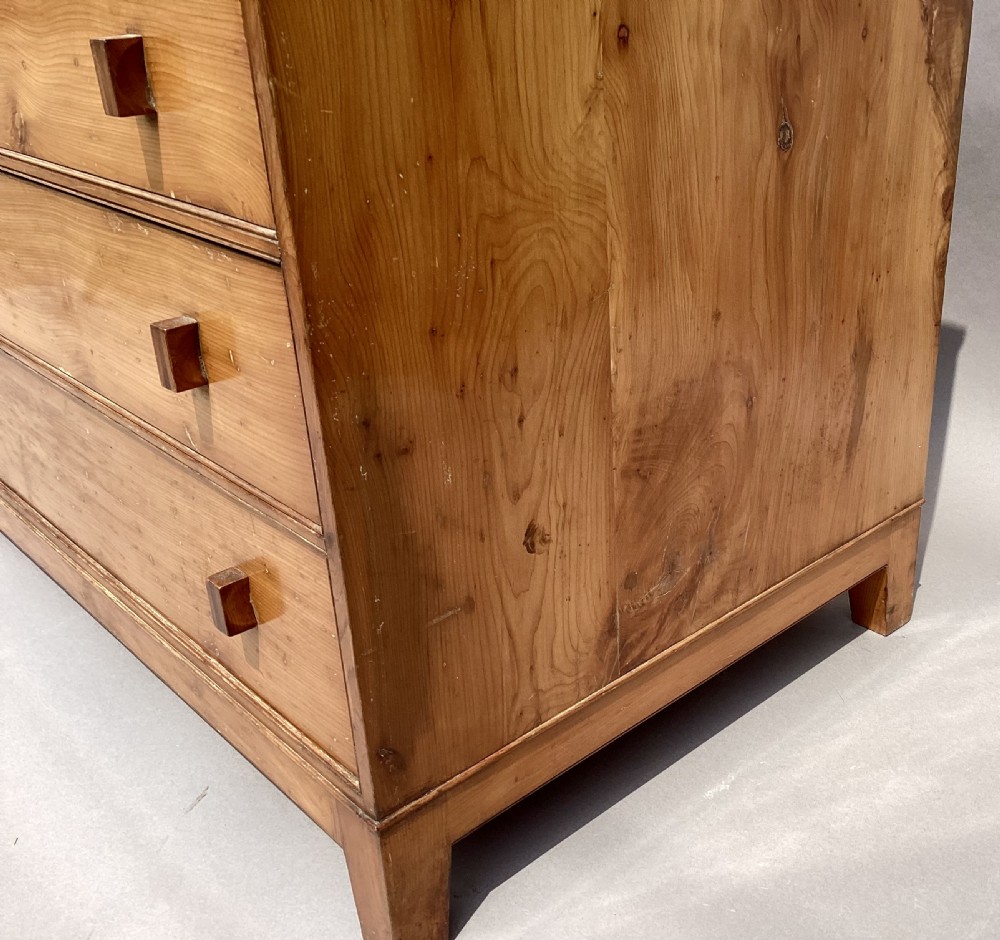 An Arts and Crafts solid yew wood chest featuring six graduated drawers with simple square wooden pulls. View VI