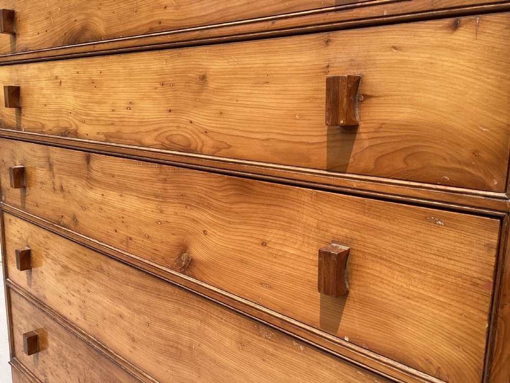 An Arts and Crafts solid yew wood chest featuring six graduated drawers with simple square wooden pulls. View XI