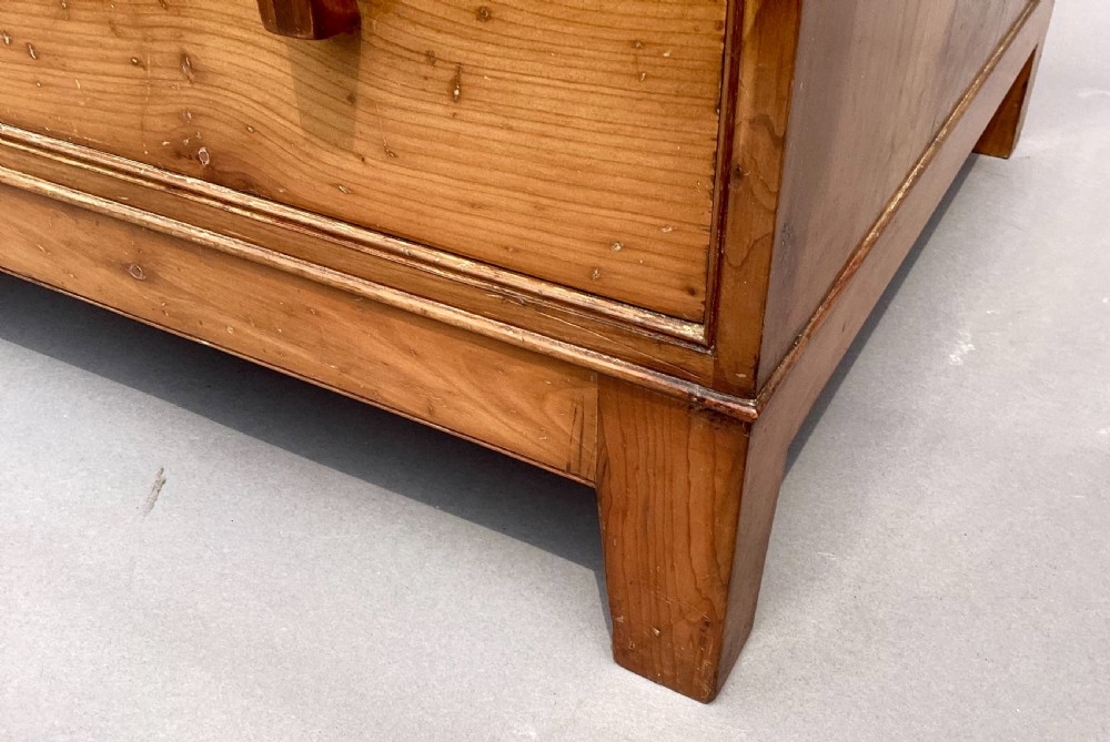An Arts and Crafts solid yew wood chest featuring six graduated drawers with simple square wooden pulls. View XV