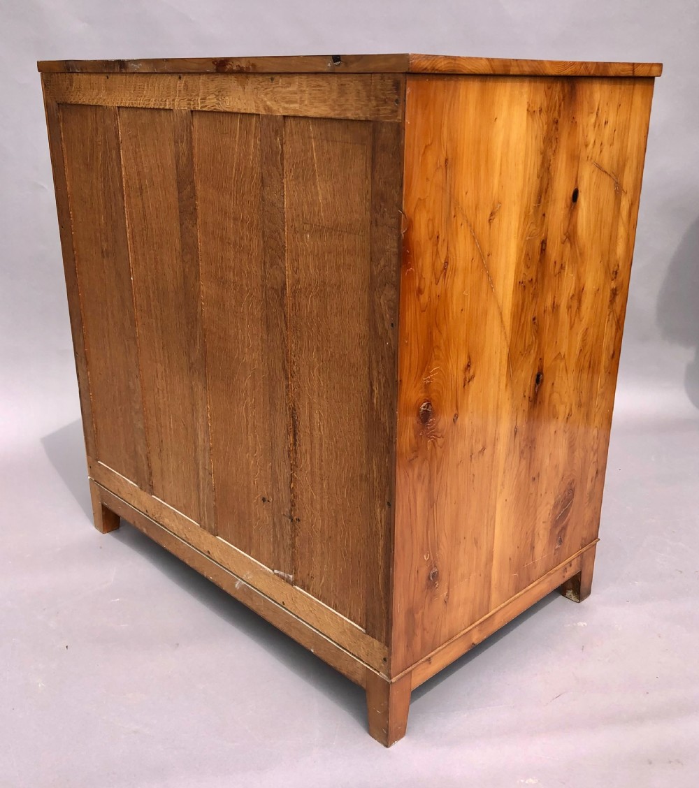 An Arts and Crafts solid yew wood chest featuring six graduated drawers with simple square wooden pulls. View XVII