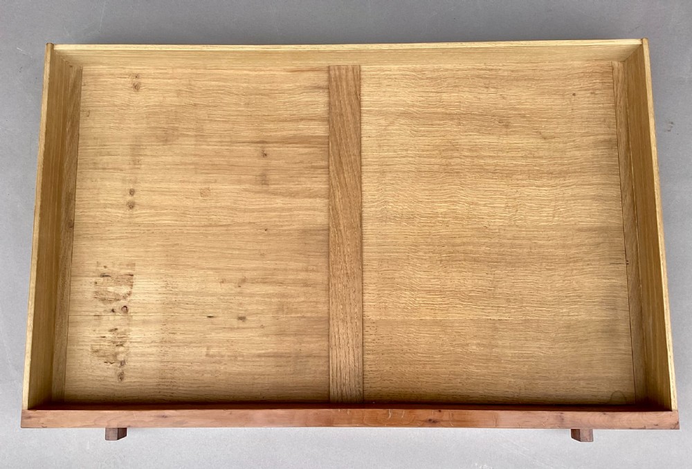 An Arts and Crafts solid yew wood chest featuring six graduated drawers with simple square wooden pulls. View XVIII