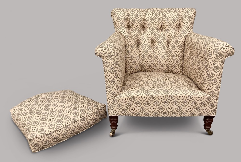 A Victorian Howard and Sons Woodstock armchair upholstered in patterned cream fabric with turned timber legs and brass castors. View VIII