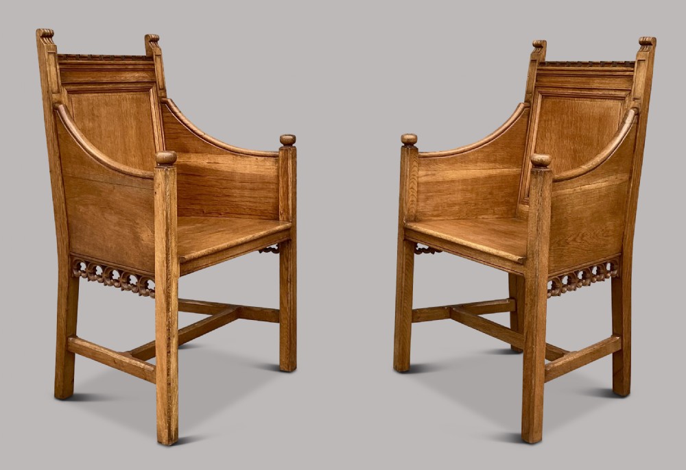 A pair of 19th-century golden oak Gothic Revival armchairs featuring high panelled backrests, shaped arms with spherical terminals, and solid oak seats. View III