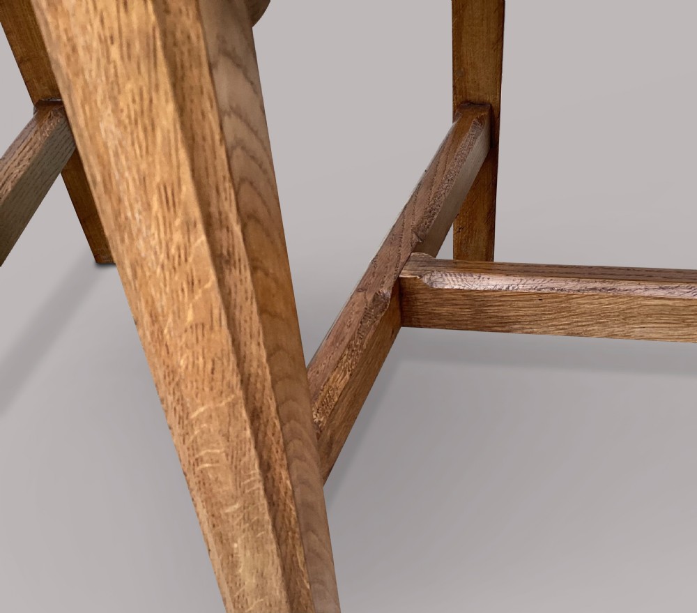 A pair of 19th-century golden oak Gothic Revival armchairs featuring high panelled backrests, shaped arms with spherical terminals, and solid oak seats. View XIX