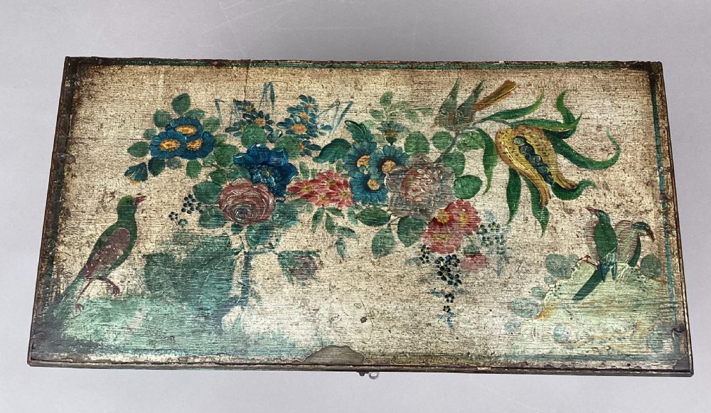 An eighteenth-century hand-painted wooden cabinet on a tall stand, featuring floral artwork across the twin doors, side panels, and apron, mounted with brass hinges. View XI