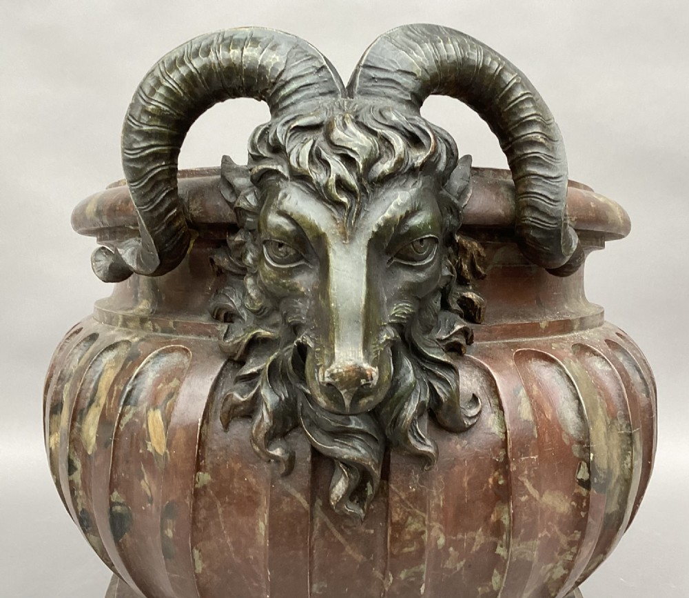 A Regency style oval wine cistern featuring a faux marble painted body with fluted decoration, cast bronze ram head handles, and an internal metal liner. View IV