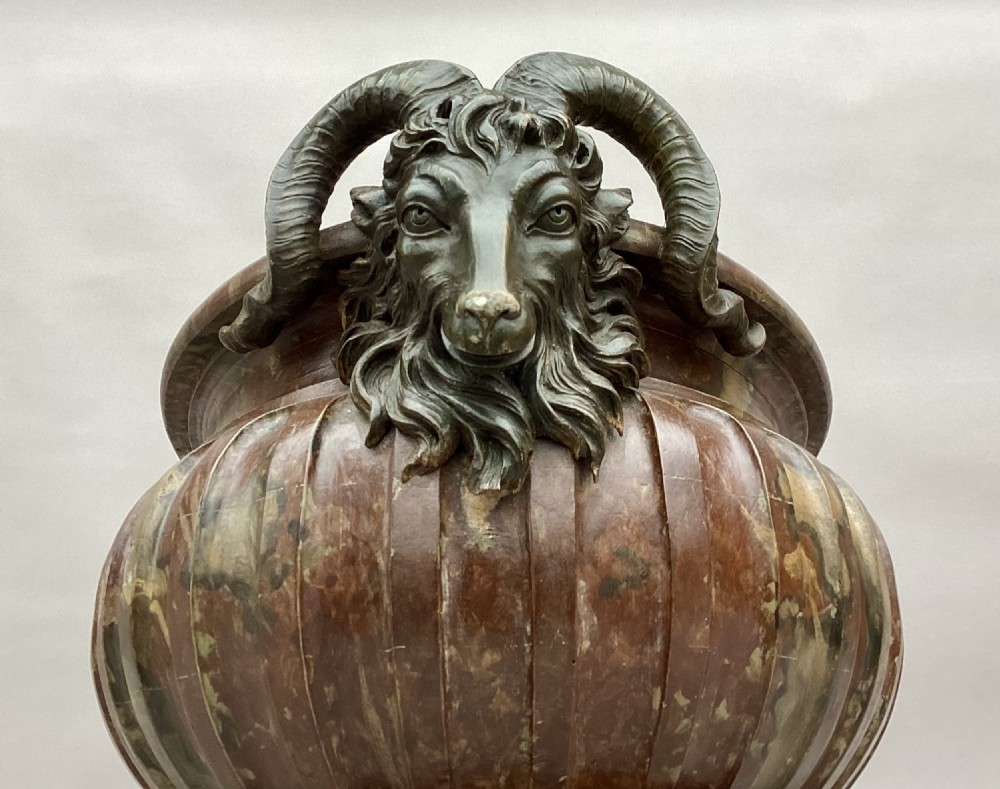 A Regency style oval wine cistern featuring a faux marble painted body with fluted decoration, cast bronze ram head handles, and an internal metal liner. View XIII