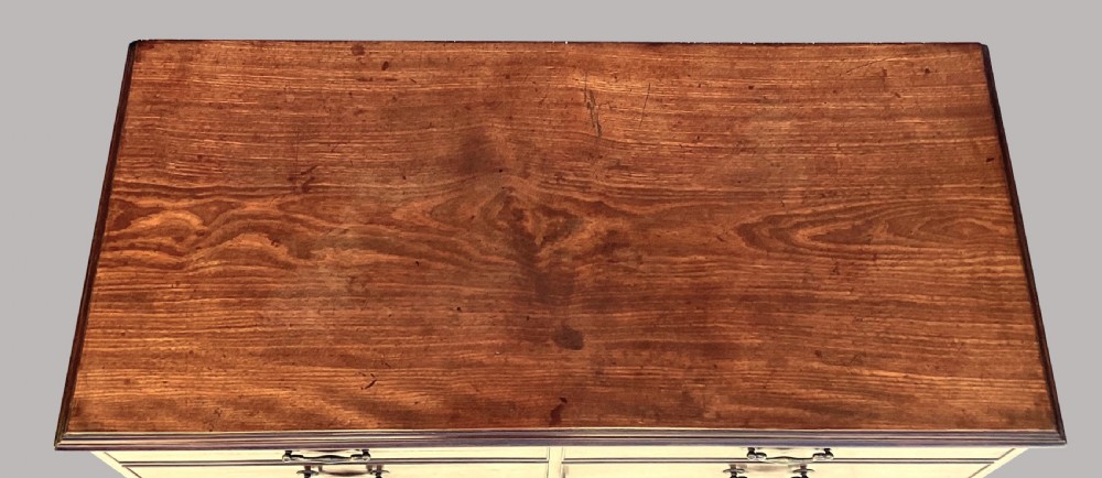 A George III mahogany low press cupboard with doors styled as faux drawers, brass swan-neck handles, bracket feet, and internal sliding shelves. View IV
