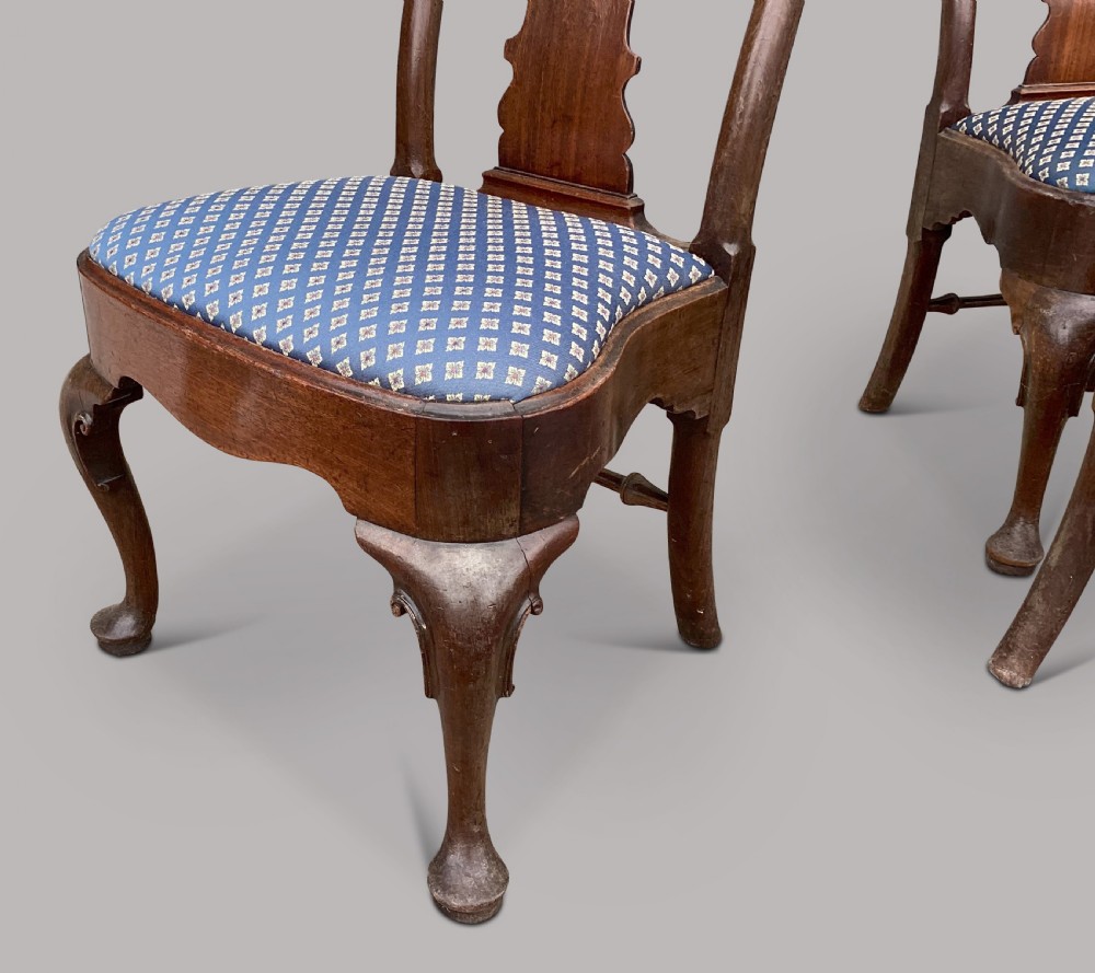A set of six George II red walnut side dining chairs with shaped vasiform splats, cabriole front legs, and blue patterned drop-in seats. View V