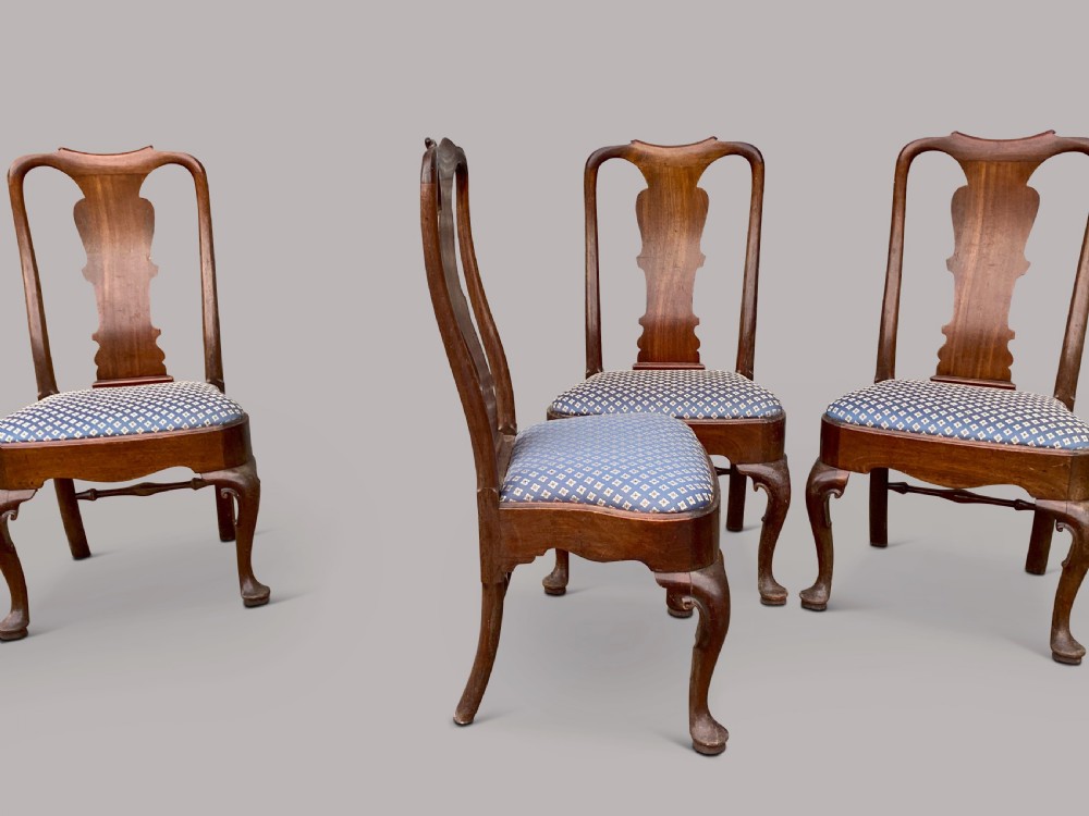 A set of six George II red walnut side dining chairs with shaped vasiform splats, cabriole front legs, and blue patterned drop-in seats. View VI