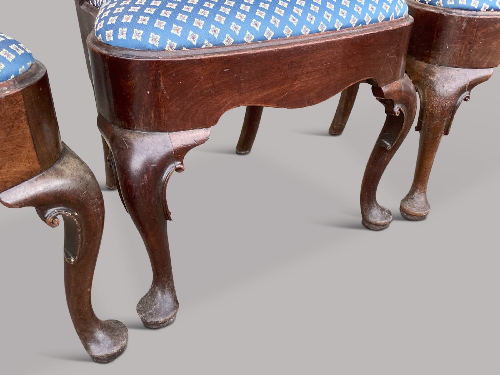 A set of six George II red walnut side dining chairs with shaped vasiform splats, cabriole front legs, and blue patterned drop-in seats. View VII