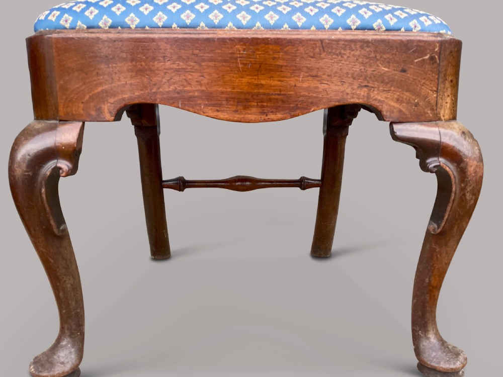 A set of six George II red walnut side dining chairs with shaped vasiform splats, cabriole front legs, and blue patterned drop-in seats. View VIII