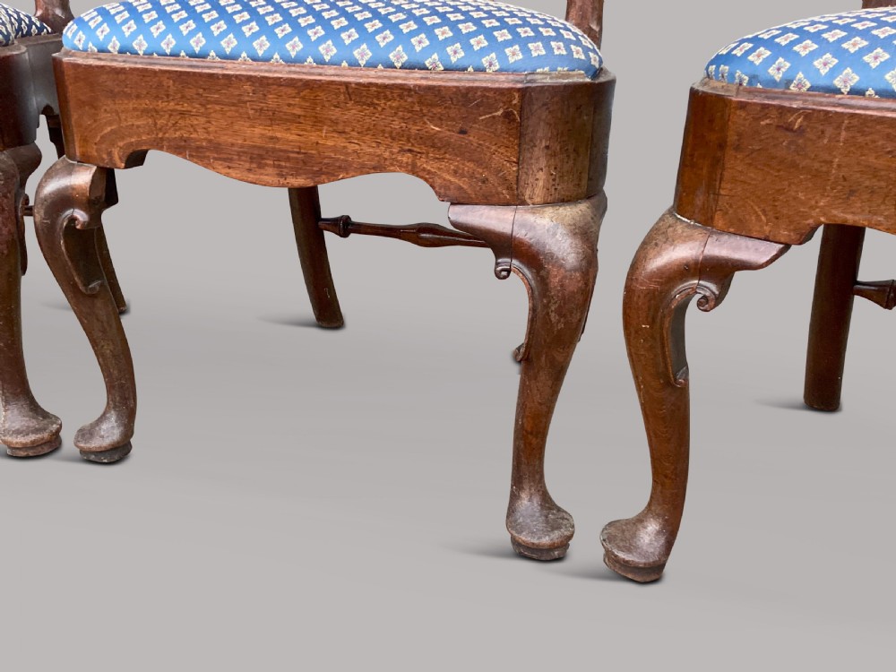 A set of six George II red walnut side dining chairs with shaped vasiform splats, cabriole front legs, and blue patterned drop-in seats. View IX