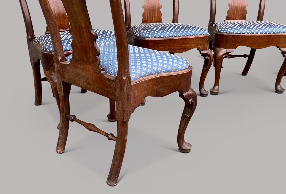 A set of six George II red walnut side dining chairs with shaped vasiform splats, cabriole front legs, and blue patterned drop-in seats. View X