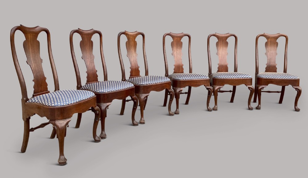 A set of six George II red walnut side dining chairs with shaped vasiform splats, cabriole front legs, and blue patterned drop-in seats. View XII