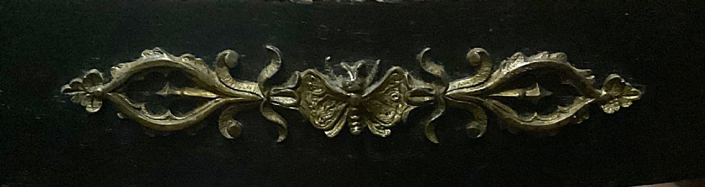A pair of Regency ebonised and gilt wooden hall chairs featuring woven cane seats, curved sabre legs, brass carrying handles, and ornate gold embellishments. View VI