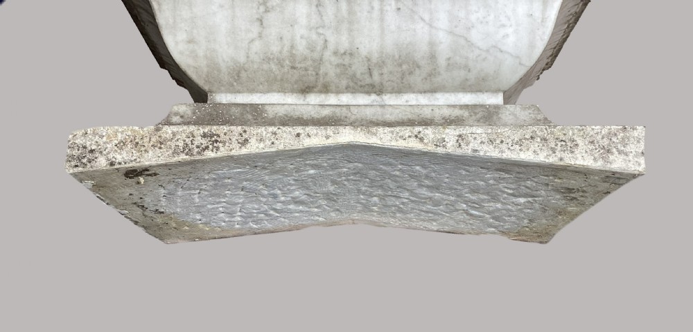 A late 18th-century Neoclassical Carrara marble cistern featuring a curved basin, flared top rim moulding, and a stepped rectangular base with a weathered stone patina. View III