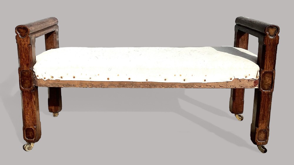 A mid-19th-century Reformed Gothic hall bench constructed from oak with burr elm inlays, featuring a padded white seat and brass castors. View II