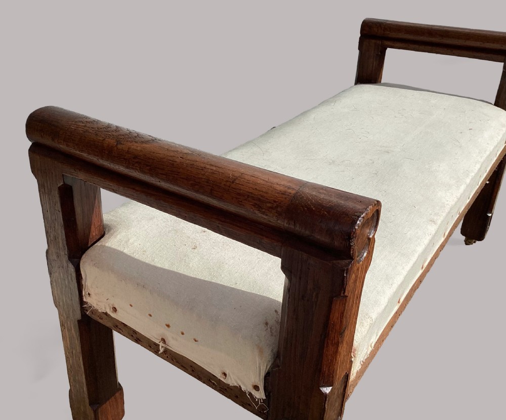 A mid-19th-century Reformed Gothic hall bench constructed from oak with burr elm inlays, featuring a padded white seat and brass castors. View XIV