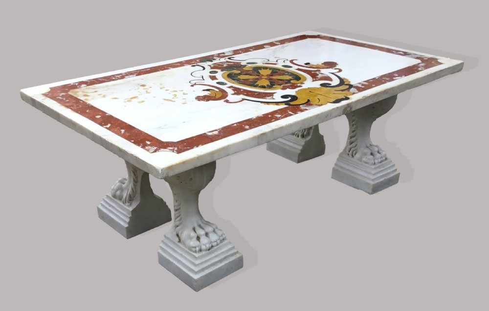 An 18th-century Italian rectangular marble coffee table featuring pietre dure specimen stone inlay and carved lion-paw pedestal supports.