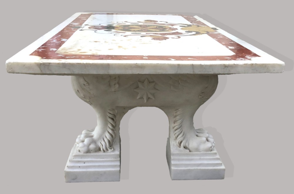 An 18th-century Italian rectangular marble coffee table featuring pietre dure specimen stone inlay and carved lion-paw pedestal supports. View V