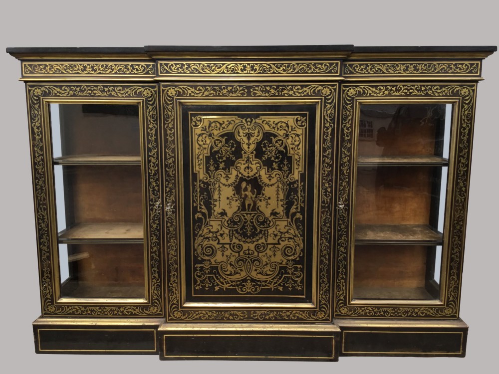 A 19th-century ebony breakfront side cabinet featuring central Boulle brass marquetry door panels flanked by two glazed display cabinet doors.
